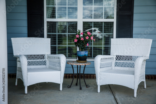 Front Porch Relaxation Wicker Chairs And Flowers Buy This Stock