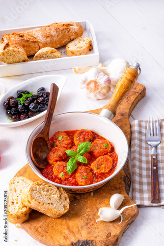 Baked mini meatballs in tomato sauce with basil © Dar1930