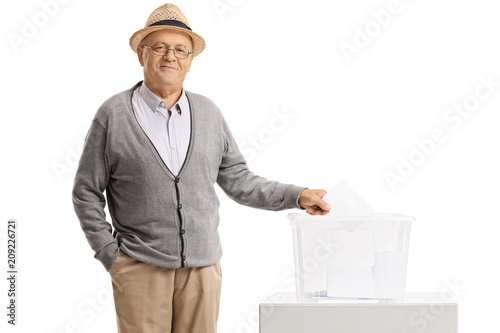 Poster Elderly man casting his vote into a ballot box