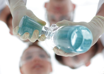 Wall Mural - image is blurred. beakers in hand, and scientists