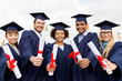 © Syda Productions - education, graduation and people concept - group of happy international students in mortar boards and bachelor gowns with diplomas
