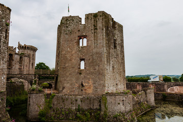 Wall Mural - Water filled moat and defensive towers of a ruined medieval castle (Raglan Castle)