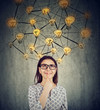 © Feodora - woman in glasses with many ideas light bulbs above head