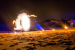 Fire show on the beach. Holiday travelers. Slow shutter speed. Night Scene, Portugal
