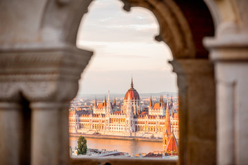 Wall Mural - View through the arch on the famous Parliament building during the sunset in Budapest, Hungary