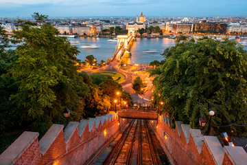 Wall Mural - Aerial cityscape view with illuminated chain bridge and funicular railway during the twilight in Budapest, Hungary