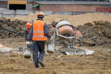 Workers At The Construction Site Prepare Concrete Mixer