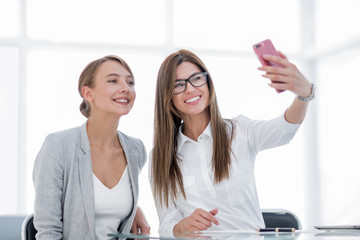 Sticker - two business women taking selfies in the office