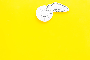 Wall Mural - clear and cloudly weather icons on yellow background top view copy space