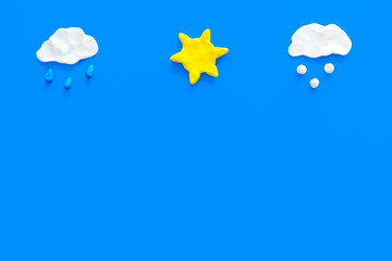 Wall Mural - clear, rainy, snow weather icons on blue background top view copy space