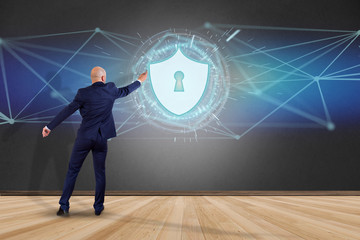 Poster - Businessman in front of a wall with security protection icon on a futuristic interface