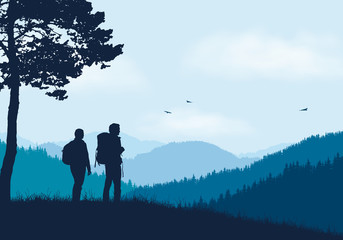 Wall Mural - two tourists with backpacks standing in mountain landscape with forest, under blue sky with clouds a