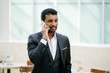 © Danon - A stylish Indian Asian businessman is talking on his smartphone. He is smiling as he talks.