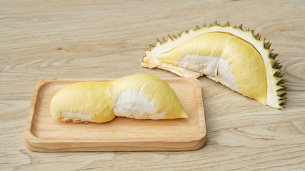 Ripe durian fruit on a wooden table.