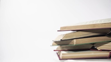 Poster - Open old book on a white wooden table, rotation 360 degrees.  Beautiful white background.