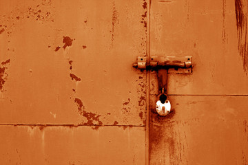 Wall Mural - Old padlock on metal gate in orange color.