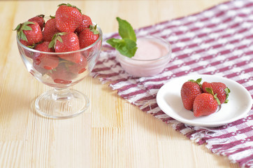 Strawberry in a bowl on a wooden table