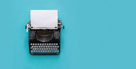 Poster - Vintage typewriter over blue background with copy space