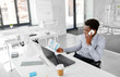 © Syda Productions - business, people, communication and technology concept - smiling african american businessman with papers and laptop computer calling on smartphone at office