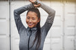 © Flamingo Images - Young Asian woman in sportswear smiling before a jog
