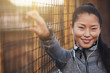 © Flamingo Images - Fit young Asian woman listening to music outdoors before exercis