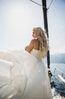 Beautiful stylish bride in a white wedding dress on luxury yacht sailing down the sea on wedding day