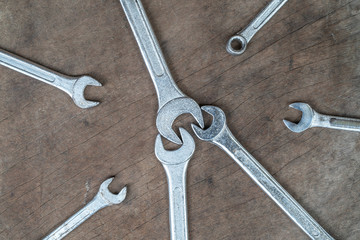 Old wrench on wood background