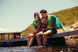 © Jacob Lund - Couple enjoying on pier at the lake