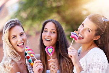 Wall Mural - Happy girl friends hanging out in the city in summer