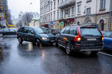 Fototapeta  - A car accident in the city in rainy weather between a minivan and an SUV. General form.