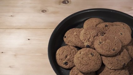 Wall Mural - Oat biscuits raisins in baking dishes, rotation 360 degrees. Beautiful wooden background.