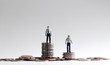 Employment and promotion gap concept. Miniature people standing on a pile of coins.