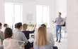 © New Africa - Male business trainer giving lecture in office