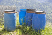 Blue Barrels And Trash In Nature And A Blue Sky