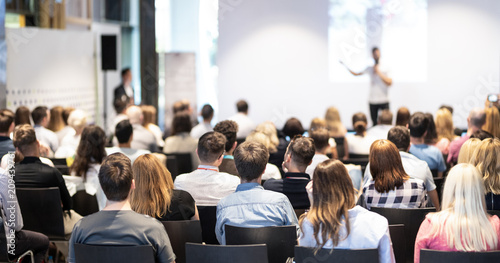 Plakaty do firmy speaker-giving-a-talk-in-conference-hall-at-business-event-audience-at-the-conference-hall-business-and-entrepreneurship-concept-focus-on-unrecognizable-people-in-audience