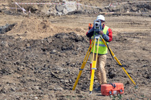 The Surveyor Is Shooting At A Building Site