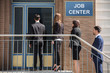 Businesspeople Standing Outside Job Center