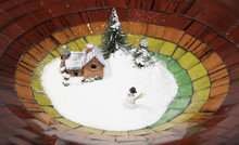 Snow Man With Snow Cover House And Christmas Tree In Colorful Plate 	