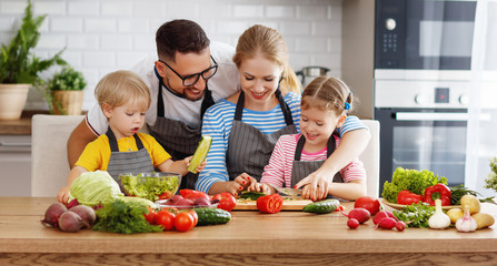 appy family with child  preparing vegetable salad