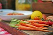 Fresh, raw vegetables for cooking:carrots with red vine-ripened cherry tomatoes and white dish background on a wooden cutting board. Selective focus. Close up.