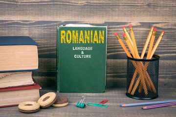 romanian language and culture concept. book on a wooden background