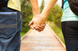 © kieferpix - Couple holding hands walking down path.
