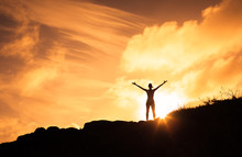 Female Standing On A Mountain With Her Arms Up In The Air. Happiness, Motivation And Feeling Good Concept. 