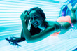 © mnelen.com - smiling young girl in a bathing suit sunbathing in a horizontal sun deck under the ultraviolet rays