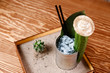 © Parilov - Refreshing cocktail with tequila cucumber, cactus and ice. Original feed in box with sand, leaf of greens.