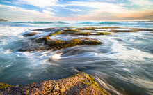 Long Exposure Of Ocean Waves Flowing Over Rocky Tidepools At Sunset On Johanna Beach In The Great Otway National Park, Victoria, Australia.