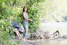 Women Fishing While Friends Watch