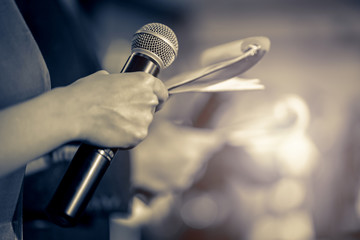 Master of ceremonies with microphone on stage