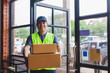 © visoot - Asia delivery man are holding a cardboard box delivery to his customer.Delivery man are checking customer from the mobile.