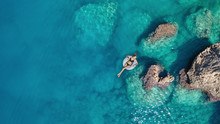Aerial View At The Girl On Sea Surface. Beautiful Composition At The Summer Time